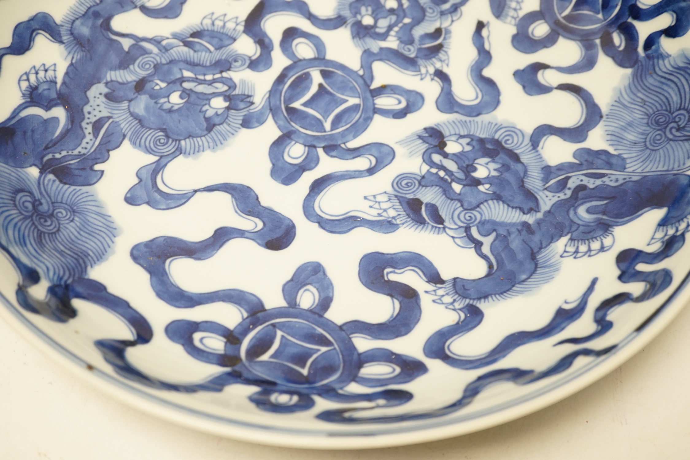 A Chinese blue and white ‘Buddhist lion’ dish, channel moulded foot, 36cm diameter